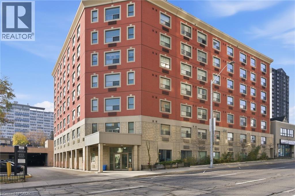 A large red building with a REALTOR® sign on the top left corner.