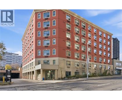 A large red building with a REALTOR® sign on the top left corner.