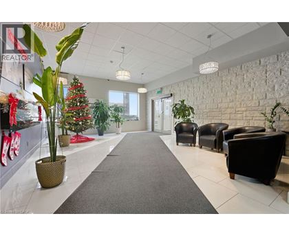 A long hallway with a Christmas tree and a REALTOR sign on the wall.