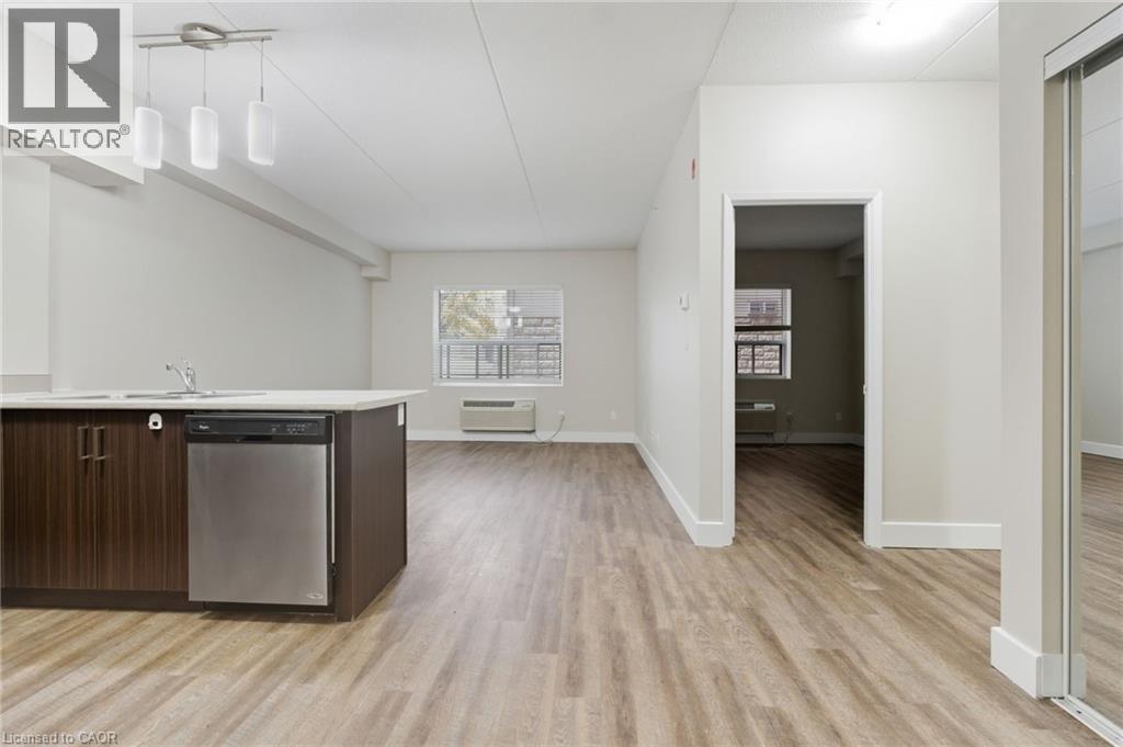 A kitchen with a dishwasher and a refrigerator.