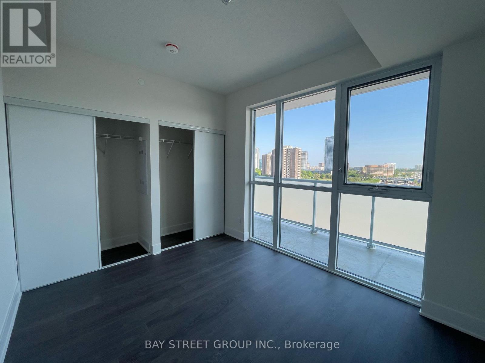 A room with a view of the city skyline through large windows.