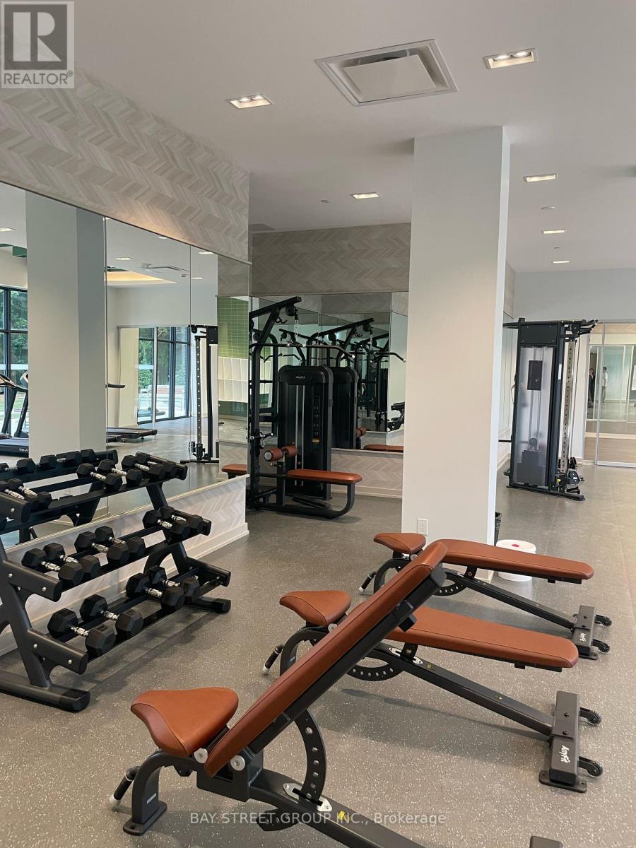 A gym with a variety of equipment including weights and cardio machines.