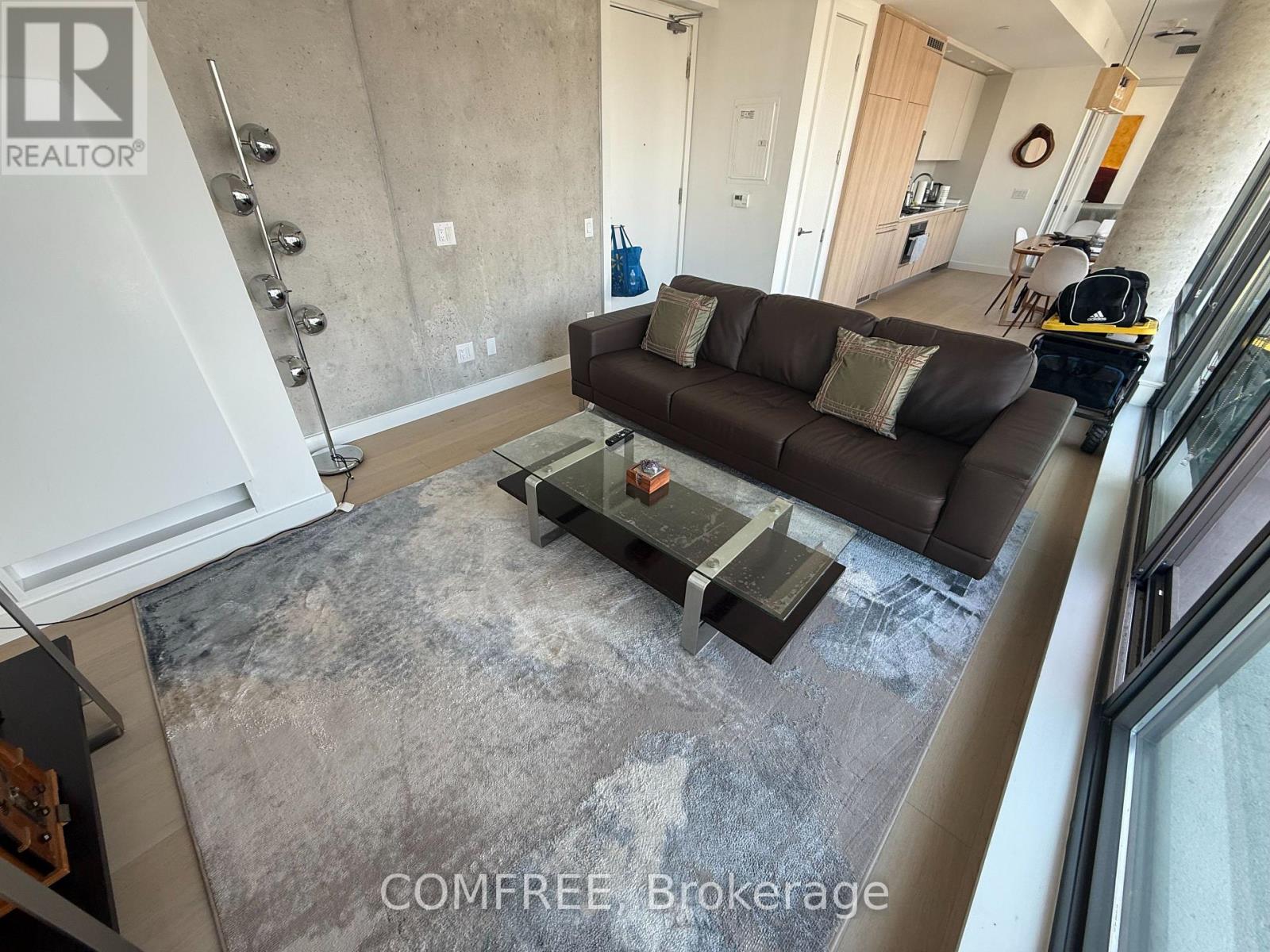 A living room with a grey couch and a table.