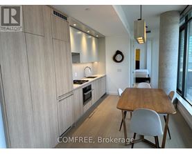 A kitchen with a table and chairs in front of a window.