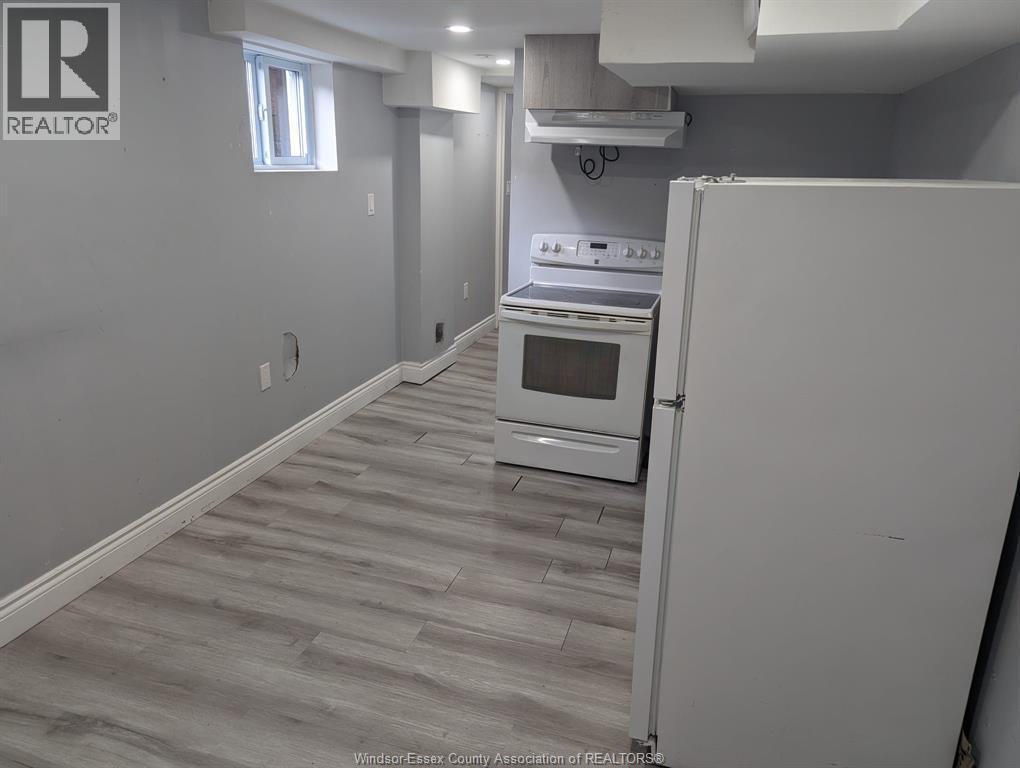 A kitchen with a white refrigerator and a stove top oven.