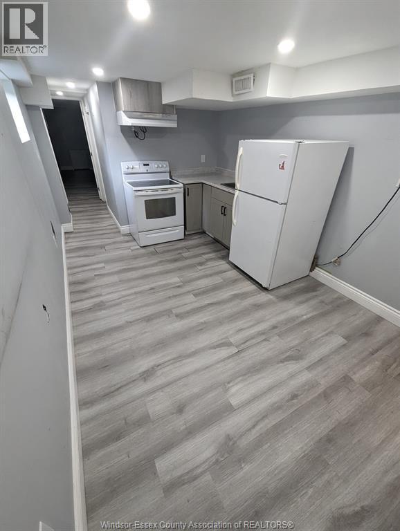 A kitchen with a white fridge and a white stove.