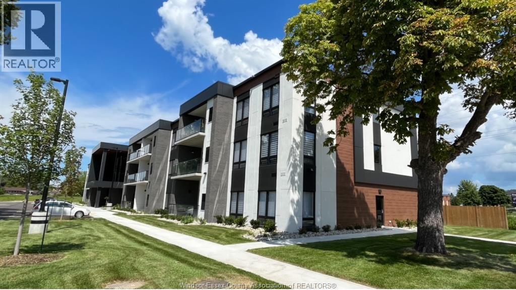 A modern apartment building with a clear blue sky above.