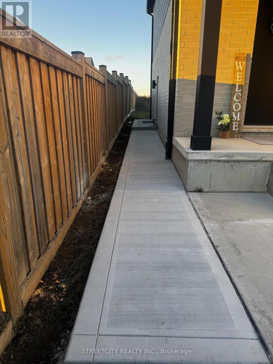 A wooden fence runs along the side of a building with a sign that says "Welcome".