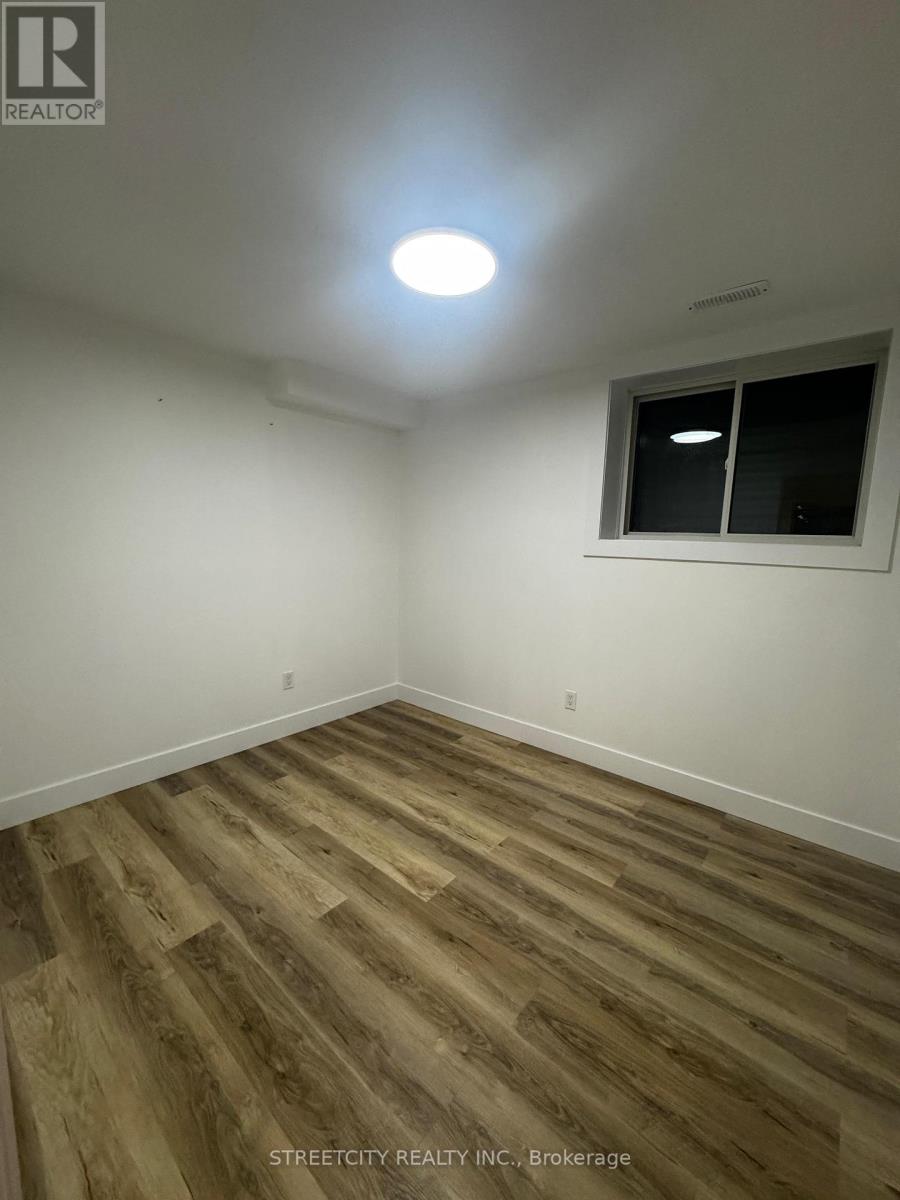 A room with wooden flooring and a window.