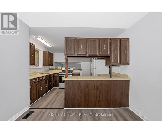 A kitchen with wooden cabinets and a countertop.