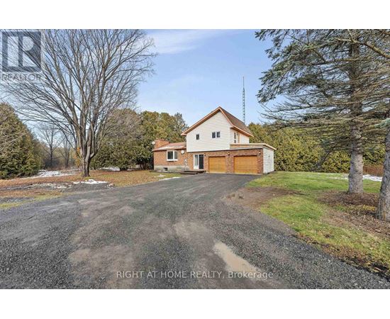 A house with a gravel driveway in front of it.
