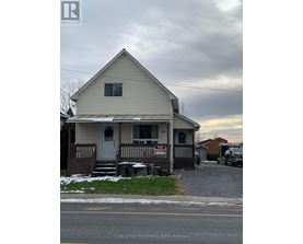 A house with a "For Rent" sign in front of it.