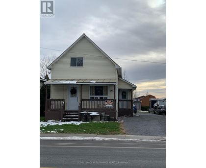 A house with a "For Rent" sign in front of it.