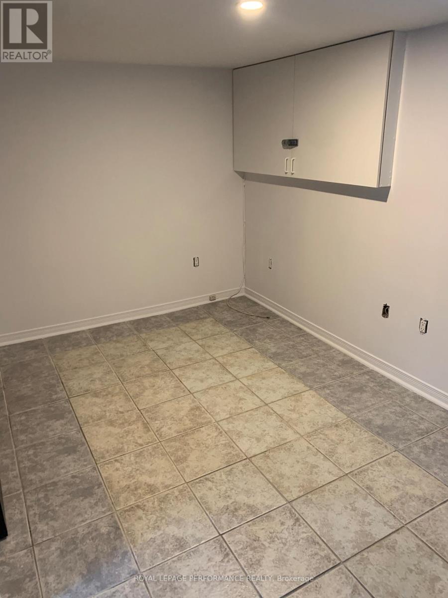 A room with a tile floor and a mirror on the wall.