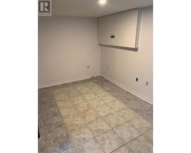 A room with a tile floor and a mirror on the wall.