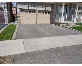 A house with a garage and a driveway in front.
