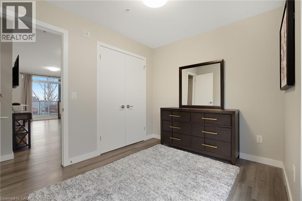 A bedroom with a large mirror and a dresser.