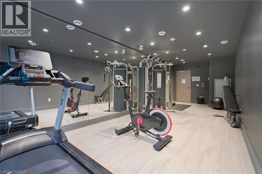 A gym with a treadmill, elliptical machines, and other exercise equipment.