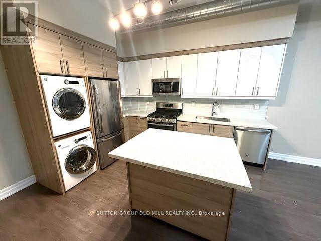 A kitchen with a white countertop and a stainless steel dishwasher.