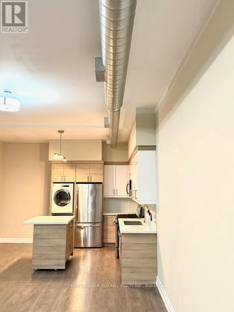A kitchen with a washer and dryer built in.