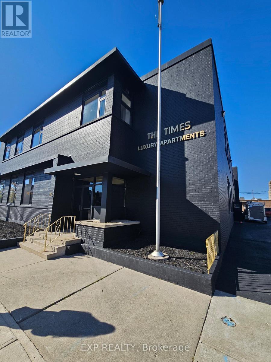 A black building with the words "The Times Luxury Apartments" on it.