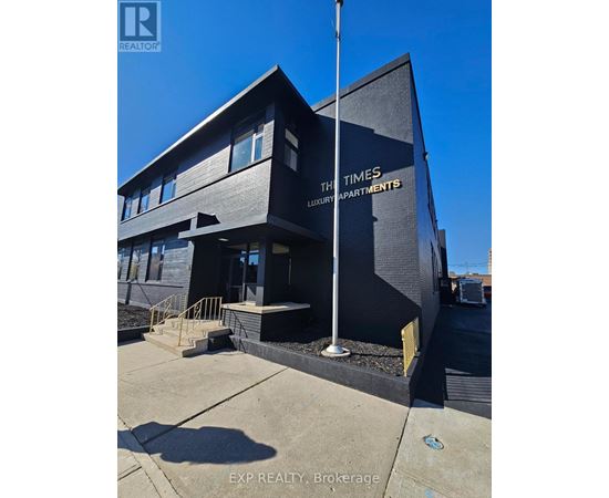 A black building with the words "The Times Luxury Apartments" on it.