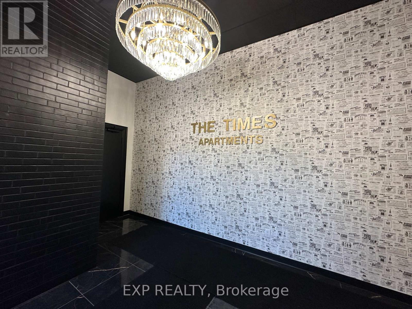 A wall covered in newspaper print with the words "The Times Apartments" written on it.