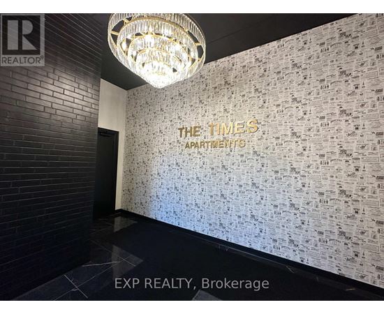A wall covered in newspaper print with the words "The Times Apartments" written on it.