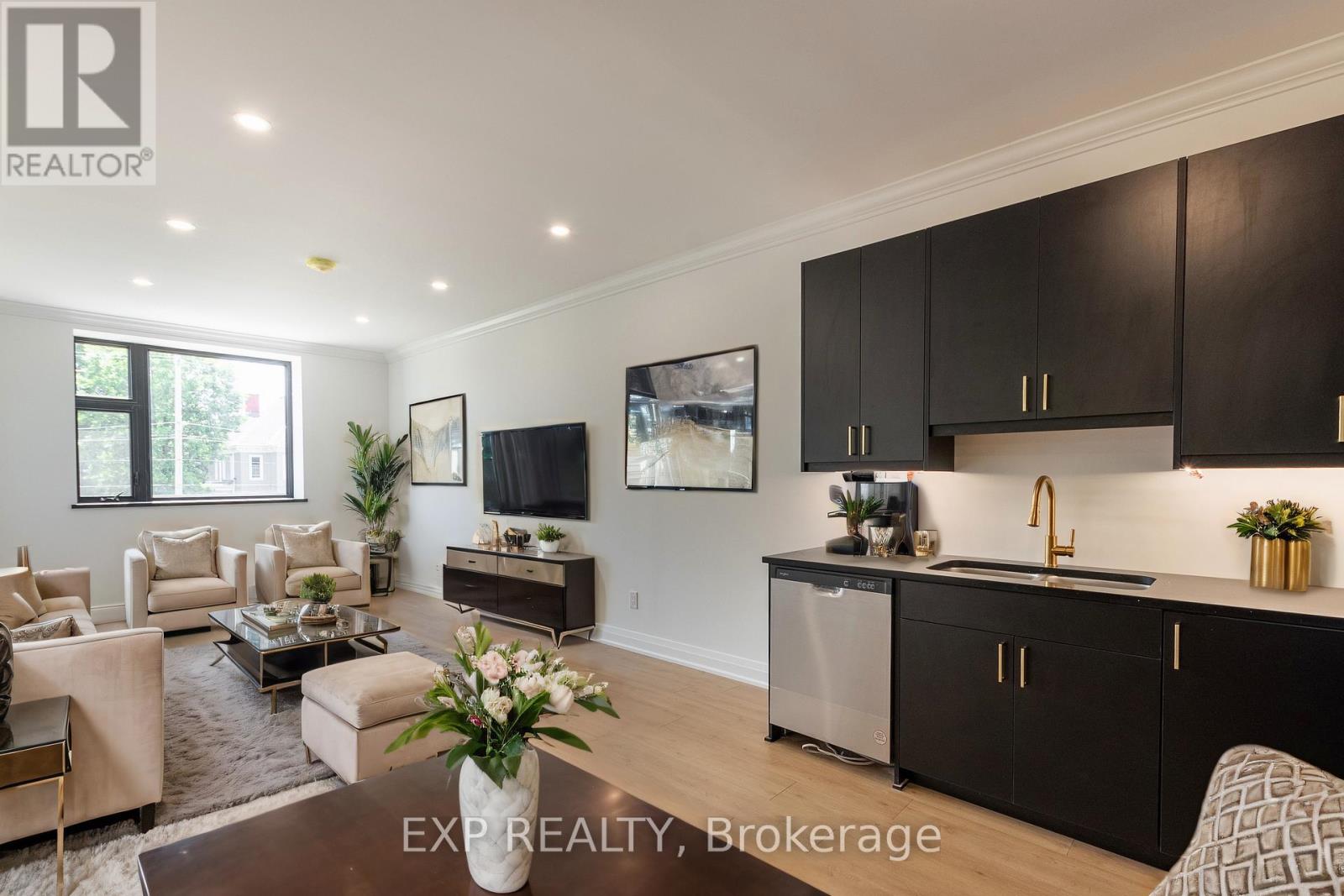 A modern kitchen with dark brown cabinets and a central island.