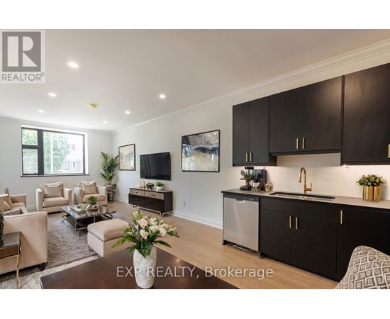 A modern kitchen with dark brown cabinets and a central island.