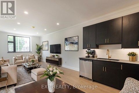 A modern kitchen with dark brown cabinets and a central island.