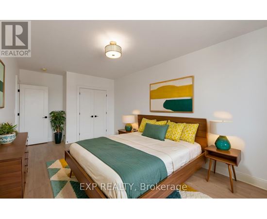 A bedroom with a bed, nightstand, and lamp.
