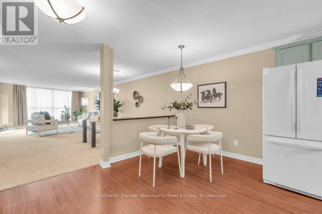 A dining room with a white table and chairs.