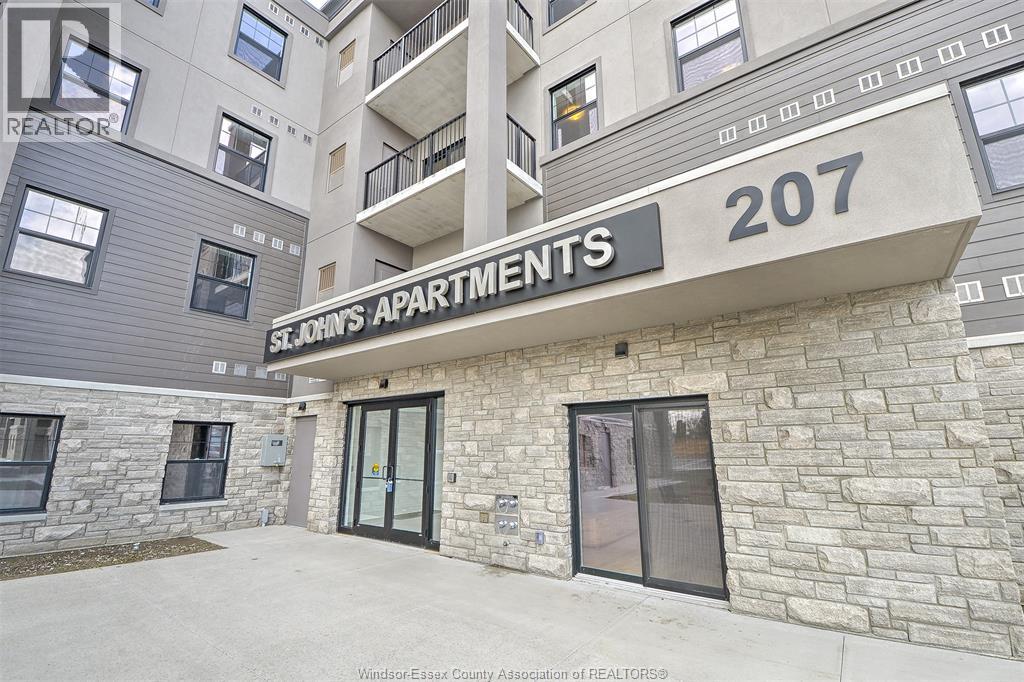 The image shows the front of a building with the sign "207 apartments" on it.
