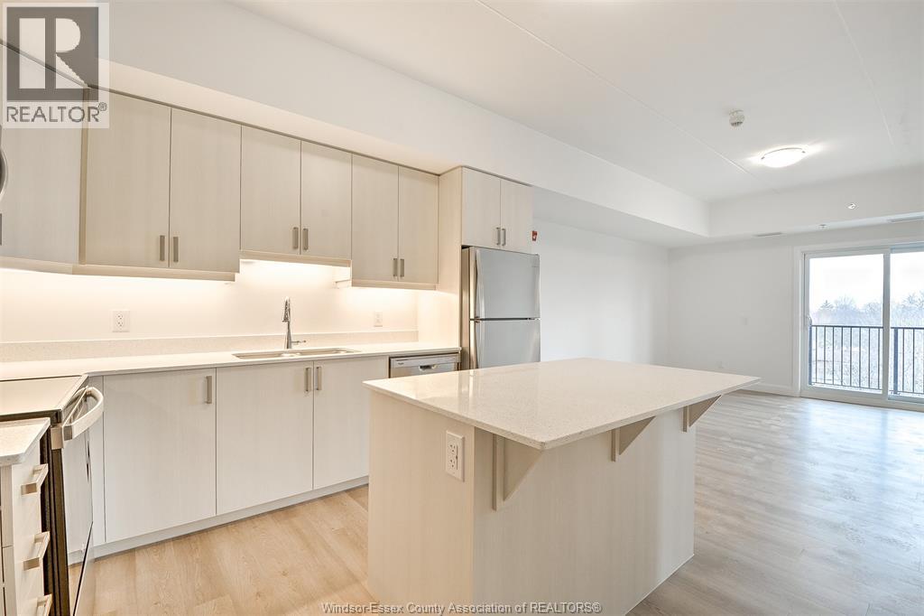 A kitchen with white cabinets and a white island.