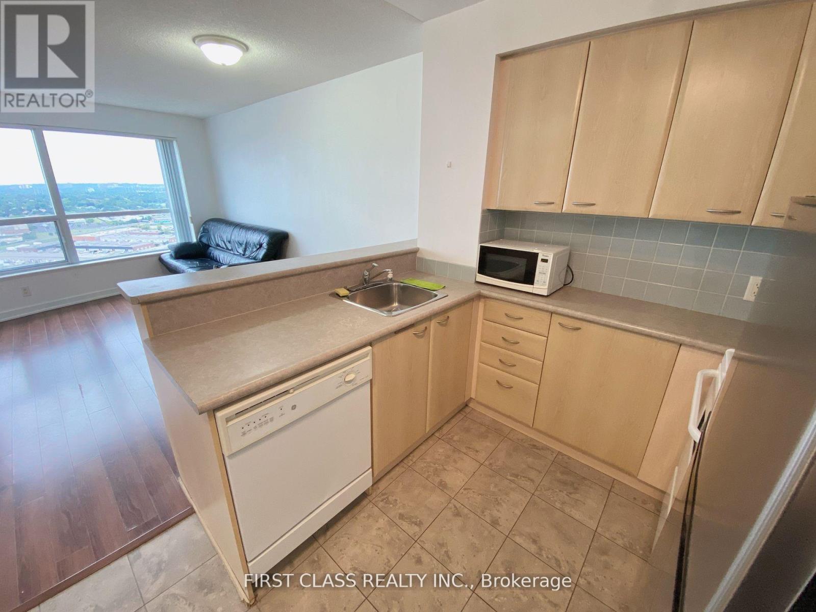 A kitchen with wooden cabinets and a tiled backsplash.
