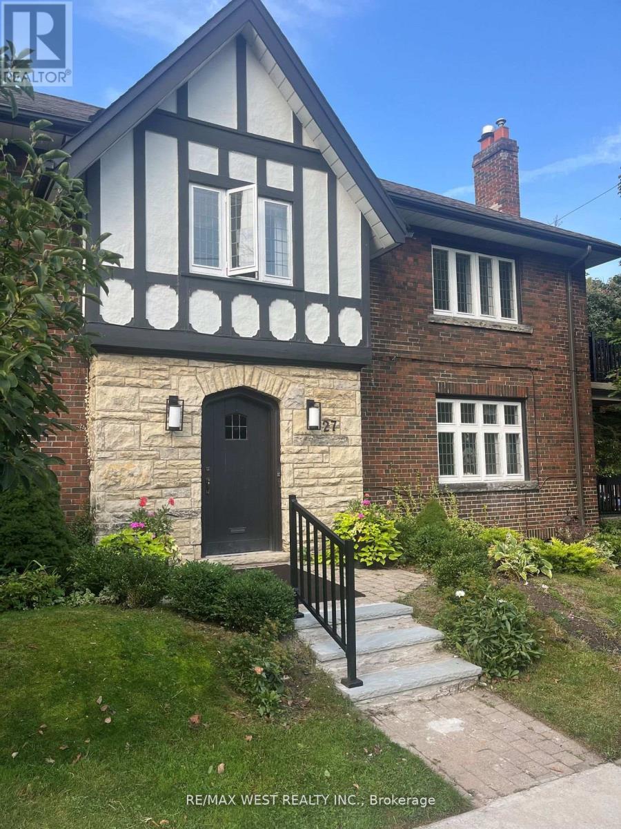 A house with a black door and windows is for sale.