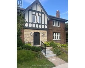 A house with a black door and windows is for sale.