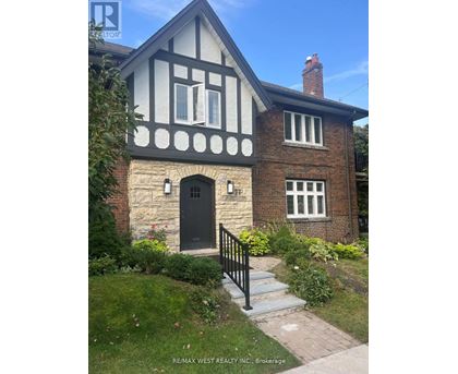 A house with a black door and windows is for sale.