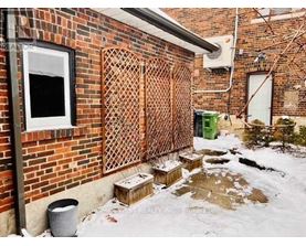 A brick wall with a lattice fence and a window.