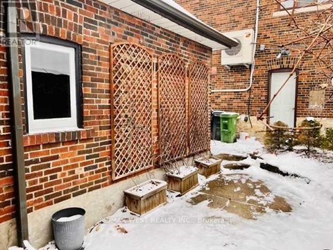 A brick wall with a lattice fence and a window.