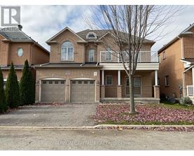 A brick house with a tree in front and a sign that says Union Capital Realty Brokerage.