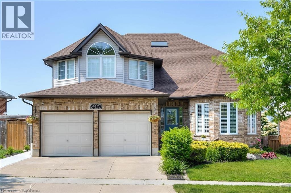 A house with a brown roof and two garage doors.