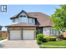 A house with a brown roof and two garage doors.