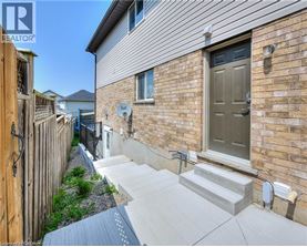 A house with a grey front door and a small garden area.