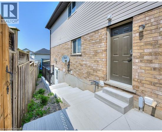 A house with a grey front door and a small garden area.