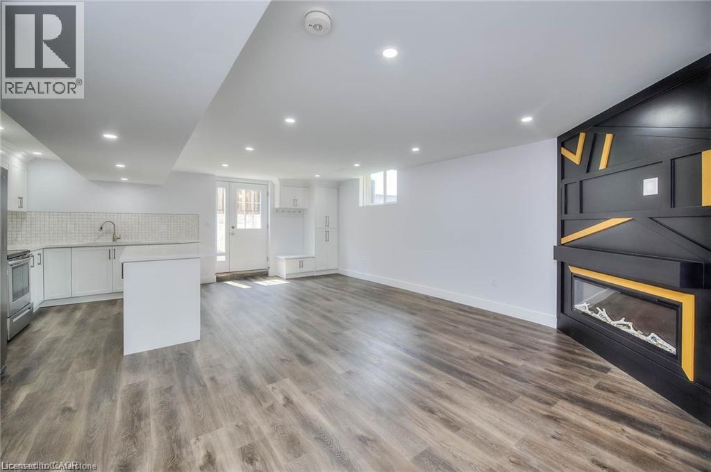 A modern living room with a fireplace and wooden flooring.