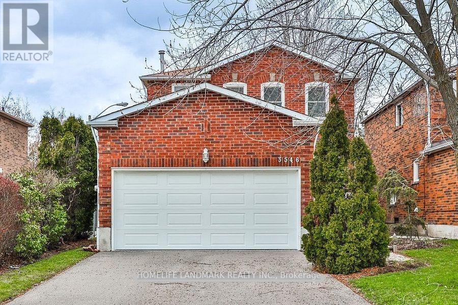 A red brick house with a white garage door.