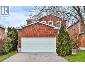 A red brick house with a white garage door.