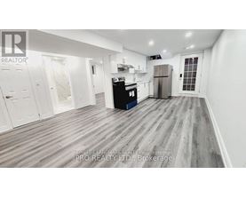 A kitchen area with a refrigerator, oven, and cabinets.